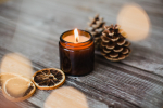 Closeup shot of decorative candles and pine cones